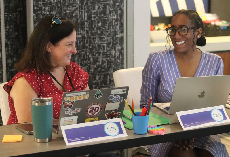 Two school leaders having a discussion during an in-person training workshop session.